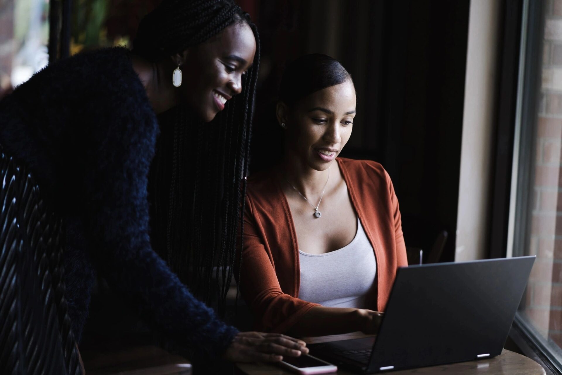 Two ladies looking into a laptop