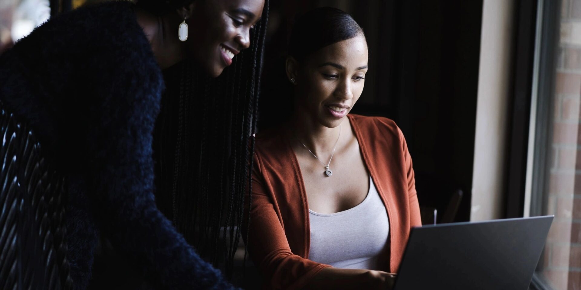 Two ladies looking into a laptop